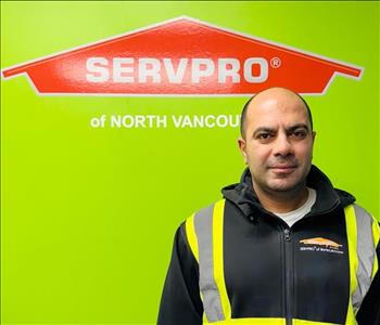 SERVPRO employee in black hoodie posing for crew photo.